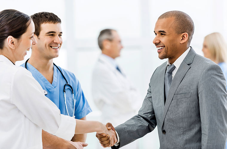 Businessman-shaking-hands-with-a-doctor-000032829234_Full